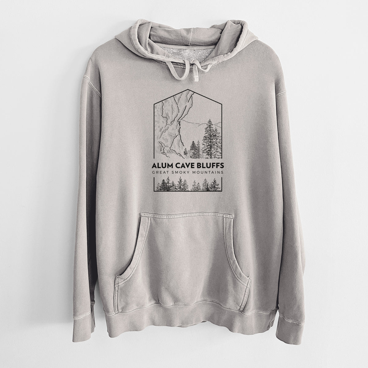 Cement grey pigment dyed hoodie laid flat, printed with a black line art badge of Alum Cave Bluffs with pine trees, with the words Alum Cave Bluffs, Great Smoky Mountains.