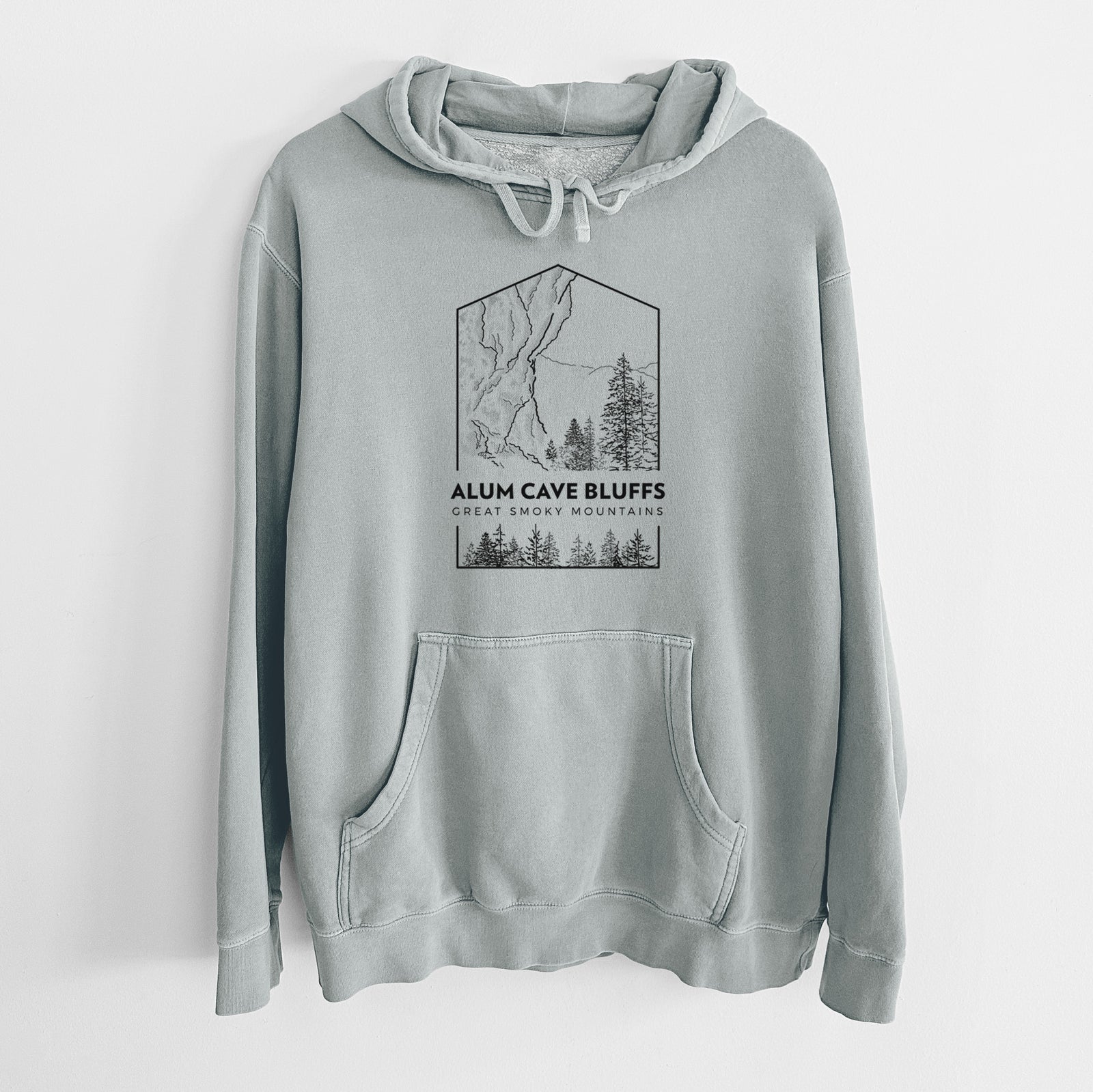 Sage green pigment dyed hoodie laid flat, printed with a black line art badge of Alum Cave Bluffs with pine trees, with the words Alum Cave Bluffs, Great Smoky Mountains.