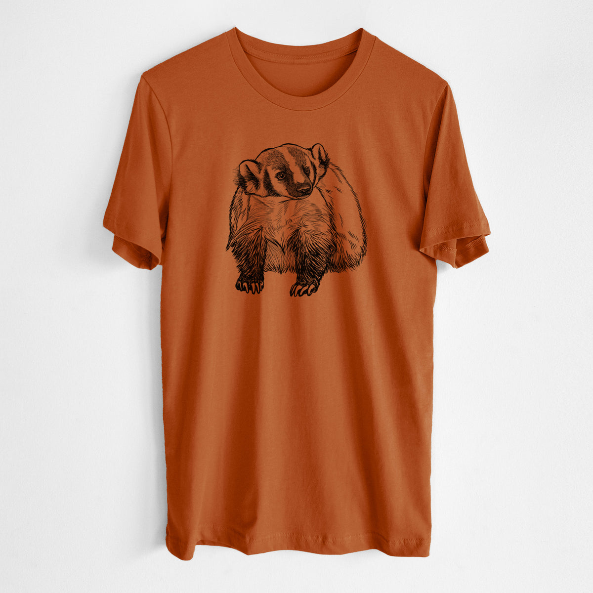 Autumn lightweight cotton t-shirt laid flat, printed with a detailed black ink illustration of an American badger facing forward.