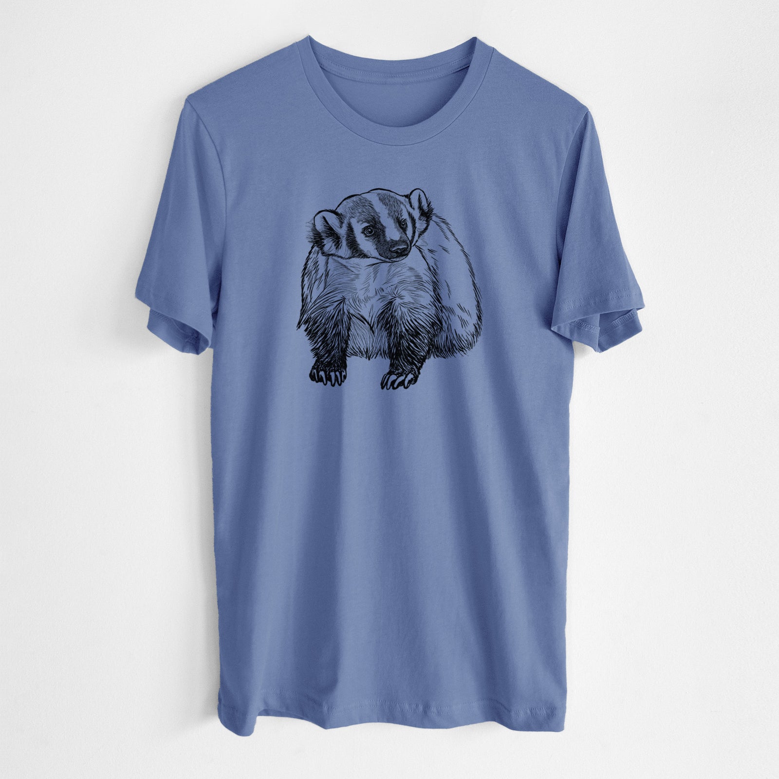 Blue bell lightweight cotton t-shirt laid flat, printed with a detailed black ink illustration of an American badger facing forward.