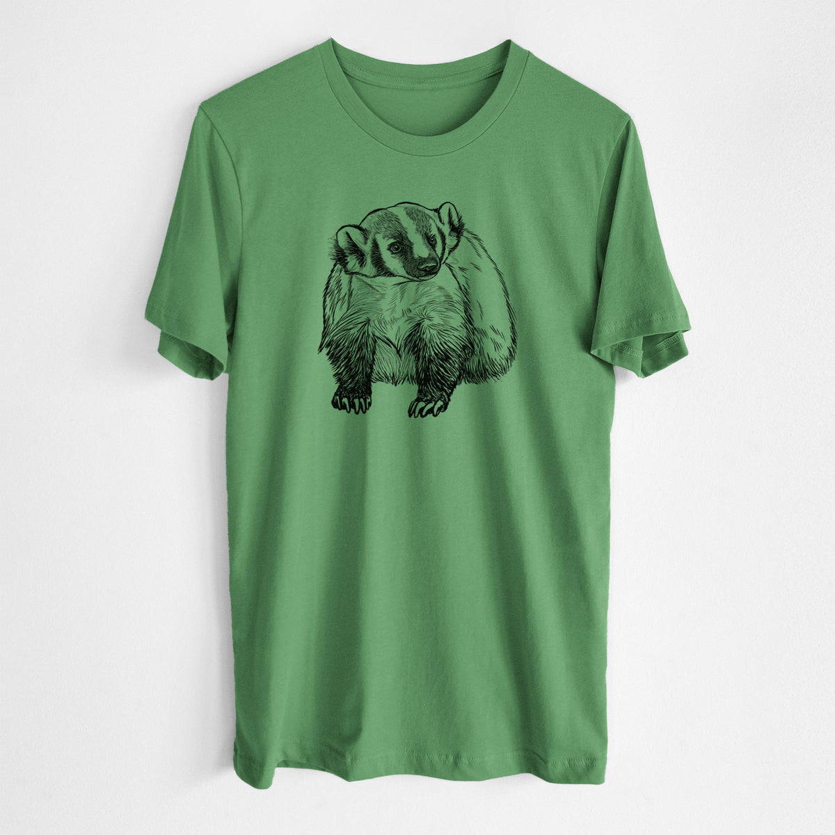 Leaf green lightweight cotton t-shirt laid flat, printed with a detailed black ink illustration of an American badger facing forward.