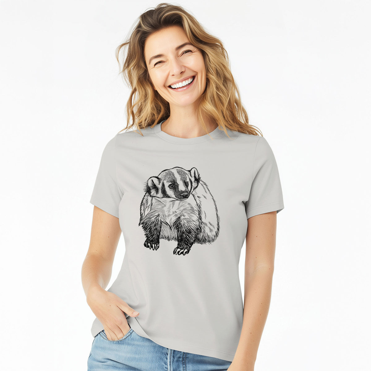 Woman wearing a lunar grey women's relaxed fit cotton t-shirt printed with a detailed black ink illustration of an American badger facing forward.