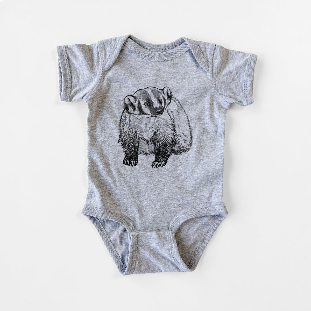 Grey baby bodysuit laid flat, printed with a detailed black ink illustration of an American badger facing forward.