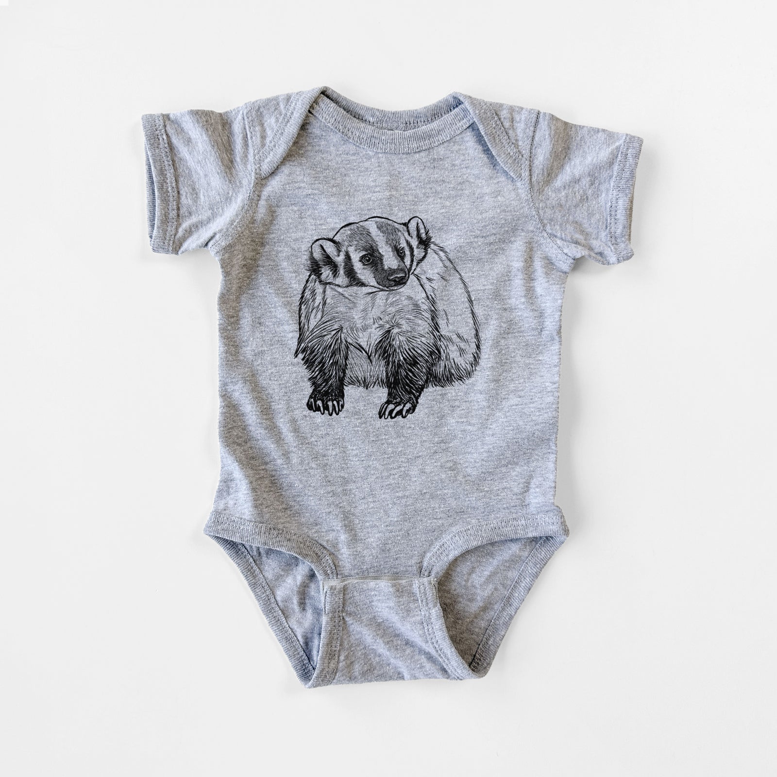 Grey baby bodysuit laid flat, printed with a detailed black ink illustration of an American badger facing forward.