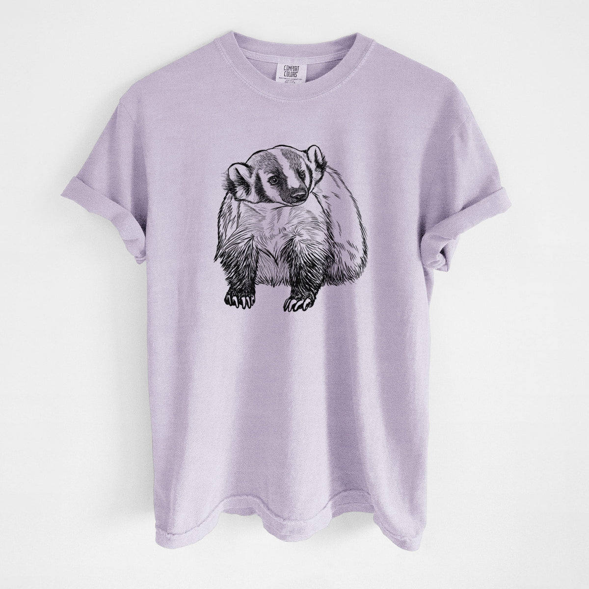 Orchid purple Comfort Colors t-shirt laid flat, printed with a detailed black ink illustration of an American badger facing forward.