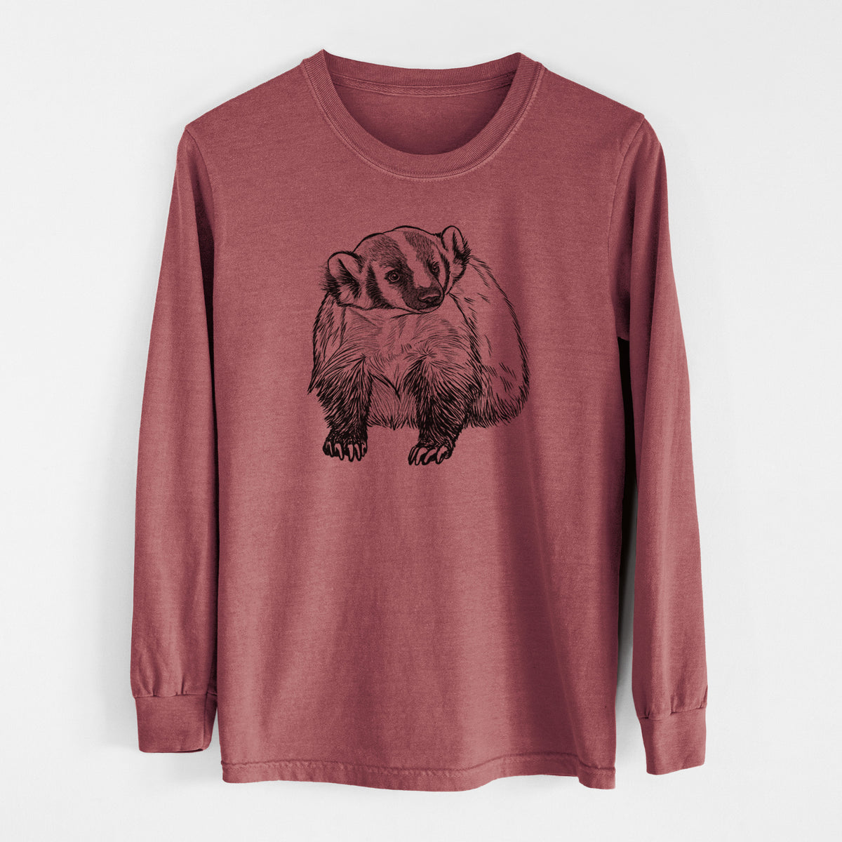 Brick red Comfort Colors long sleeve shirt laid flat, printed with a detailed black ink illustration of an American badger facing forward.