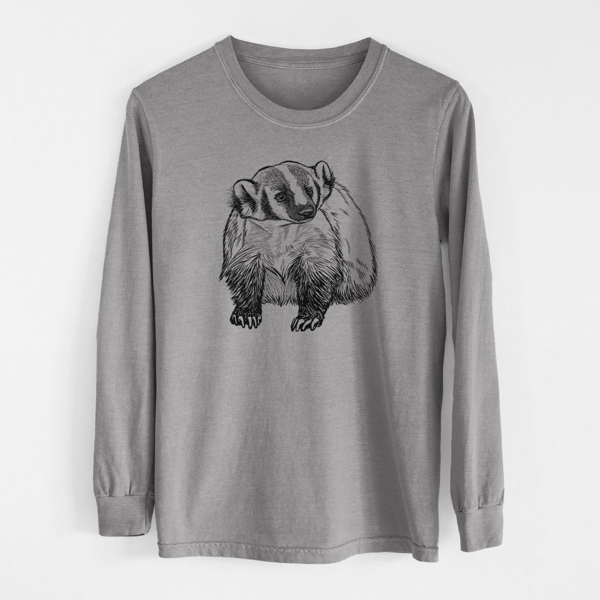 Grey Comfort Colors long sleeve shirt laid flat, printed with a detailed black ink illustration of an American badger facing forward.
