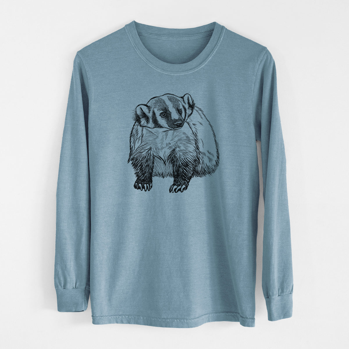 Steel blue Comfort Colors long sleeve shirt laid flat, printed with a detailed black ink illustration of an American badger facing forward.