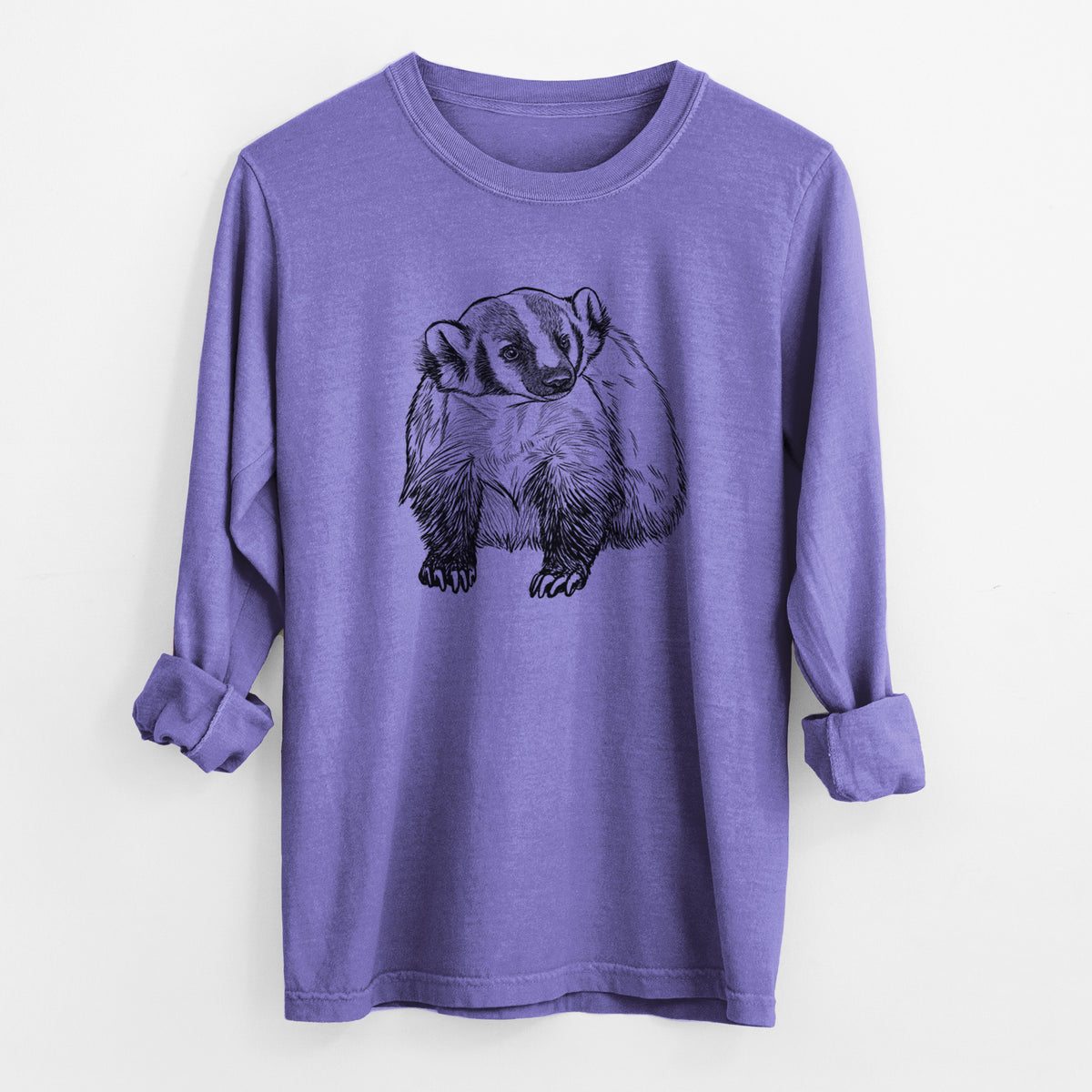 Violet purple Comfort Colors long sleeve shirt laid flat with the cuffs rolled, printed with a detailed black ink illustration of an American badger facing forward.