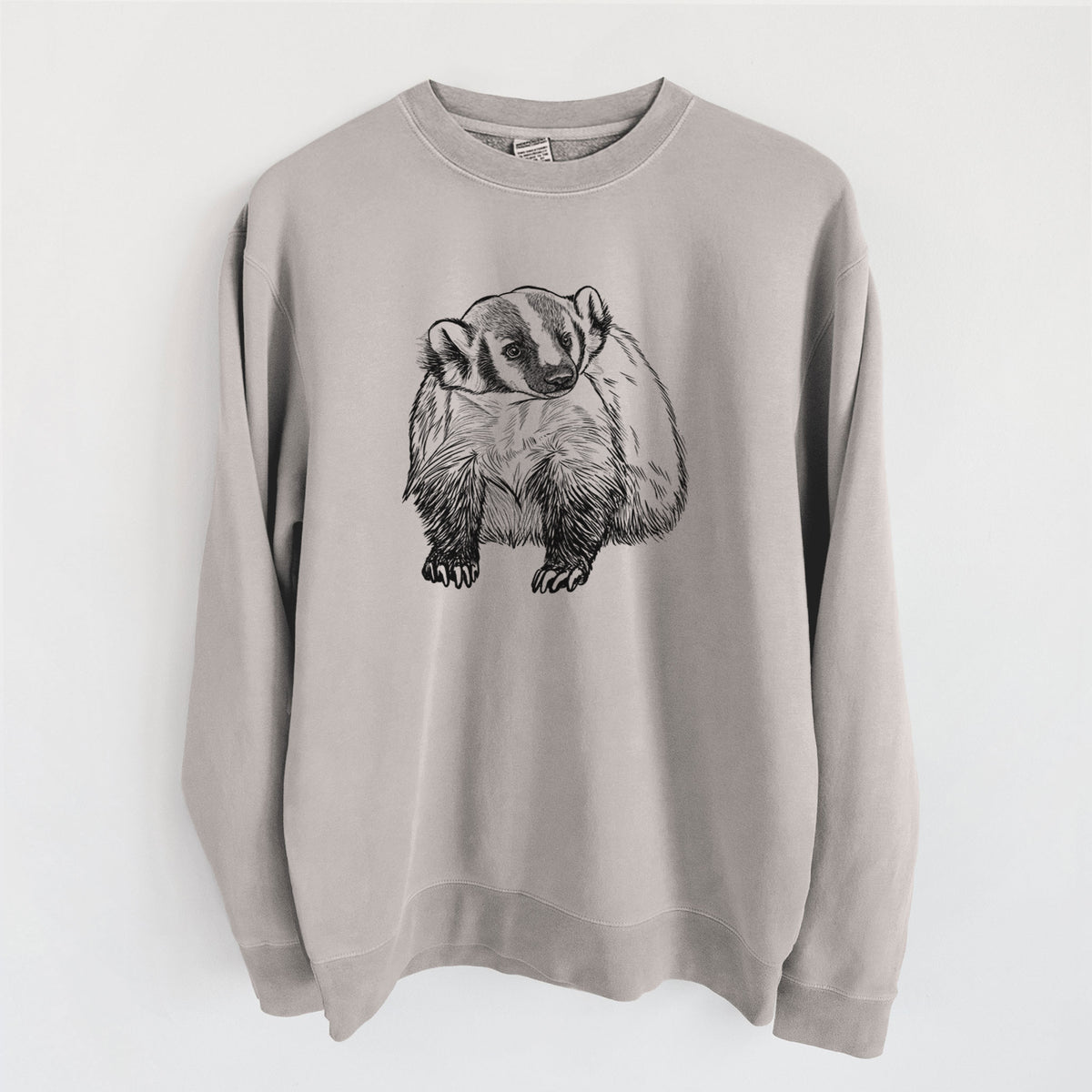 Cement grey pigment dyed crewneck sweatshirt laid flat, printed with a detailed black ink illustration of an American badger facing forward.