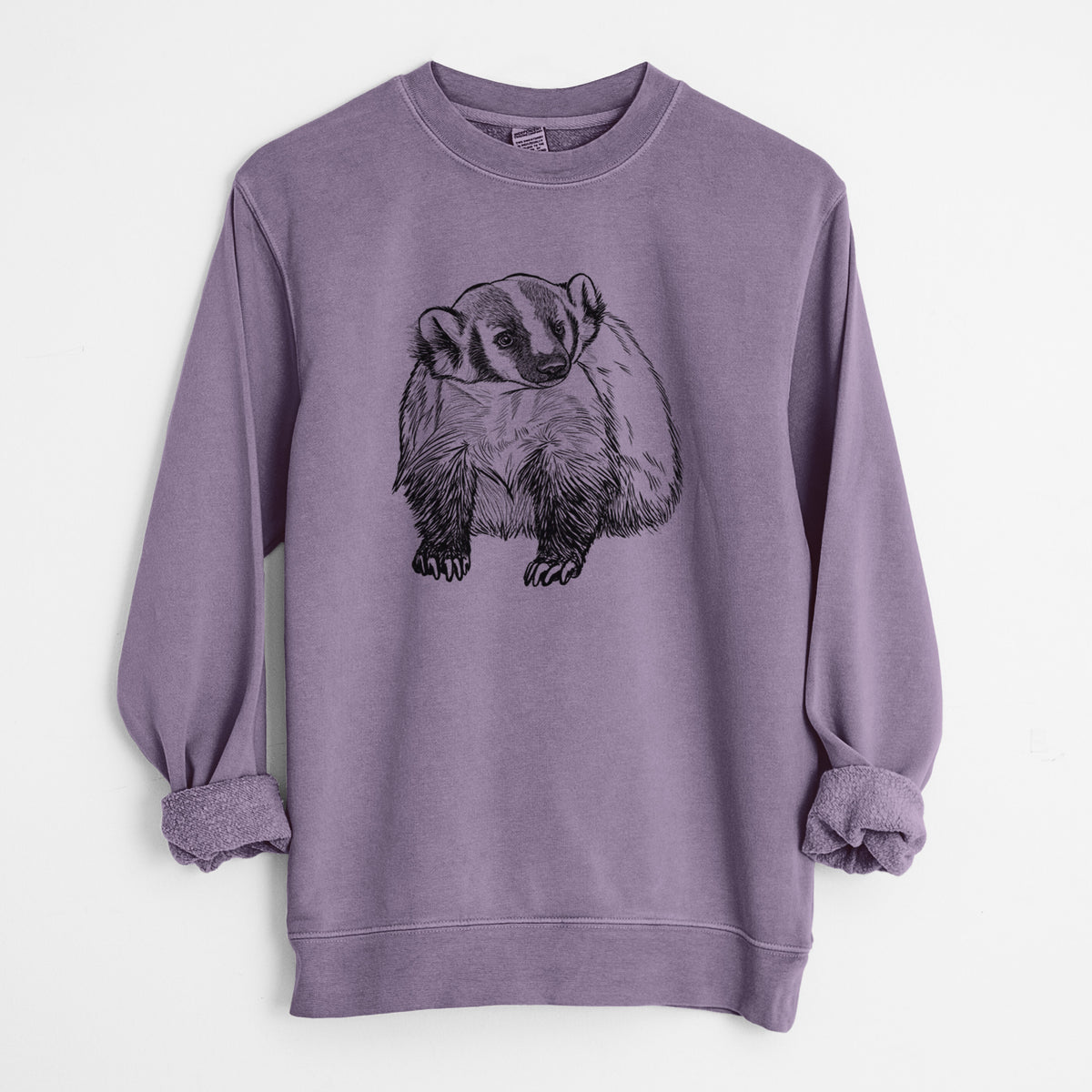 Plum purple pigment dyed crewneck sweatshirt laid flat with the sleeves rolled, printed with a detailed black ink illustration of an American badger facing forward.