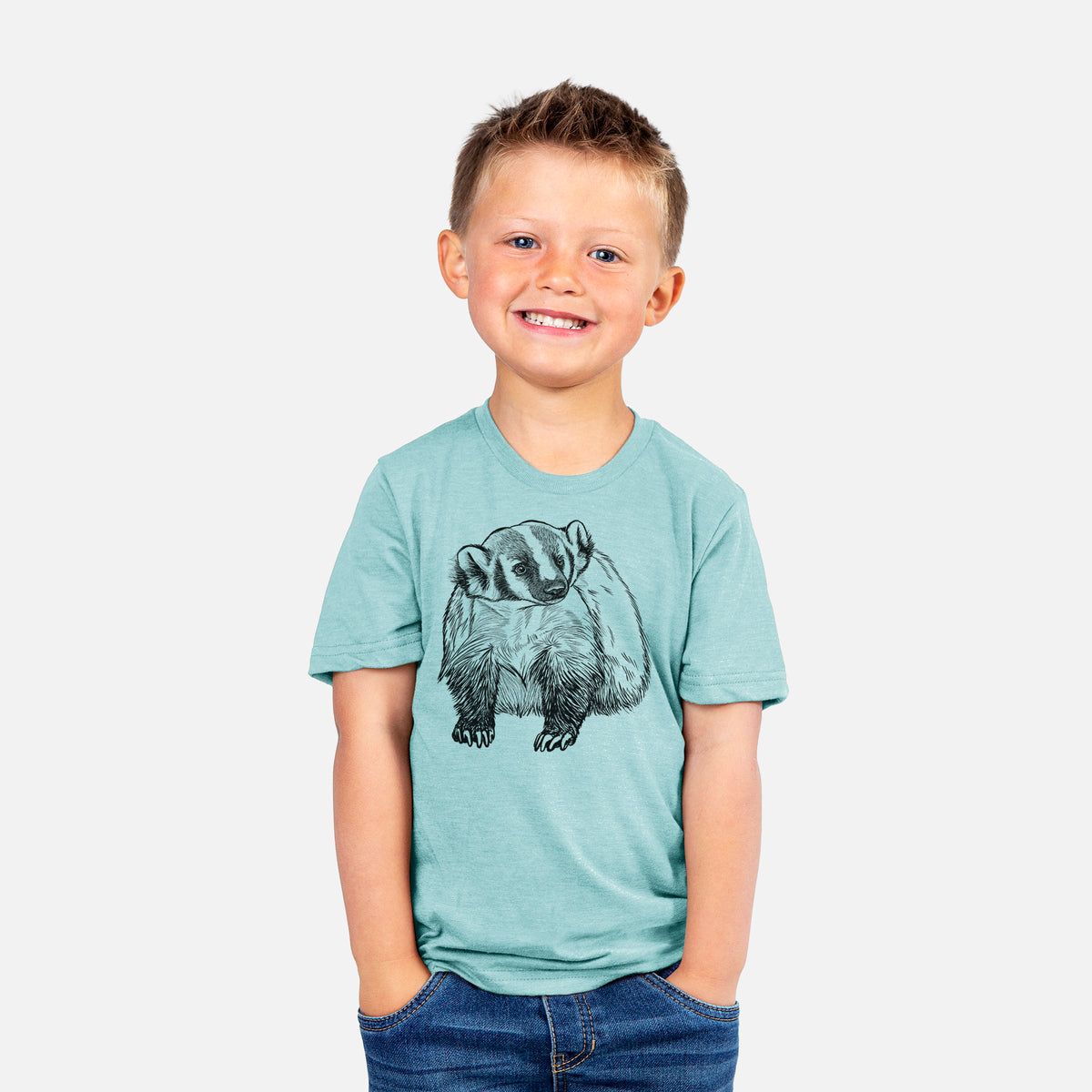 Smiling boy wearing a youth t-shirt printed with a detailed black ink illustration of an American badger facing forward.