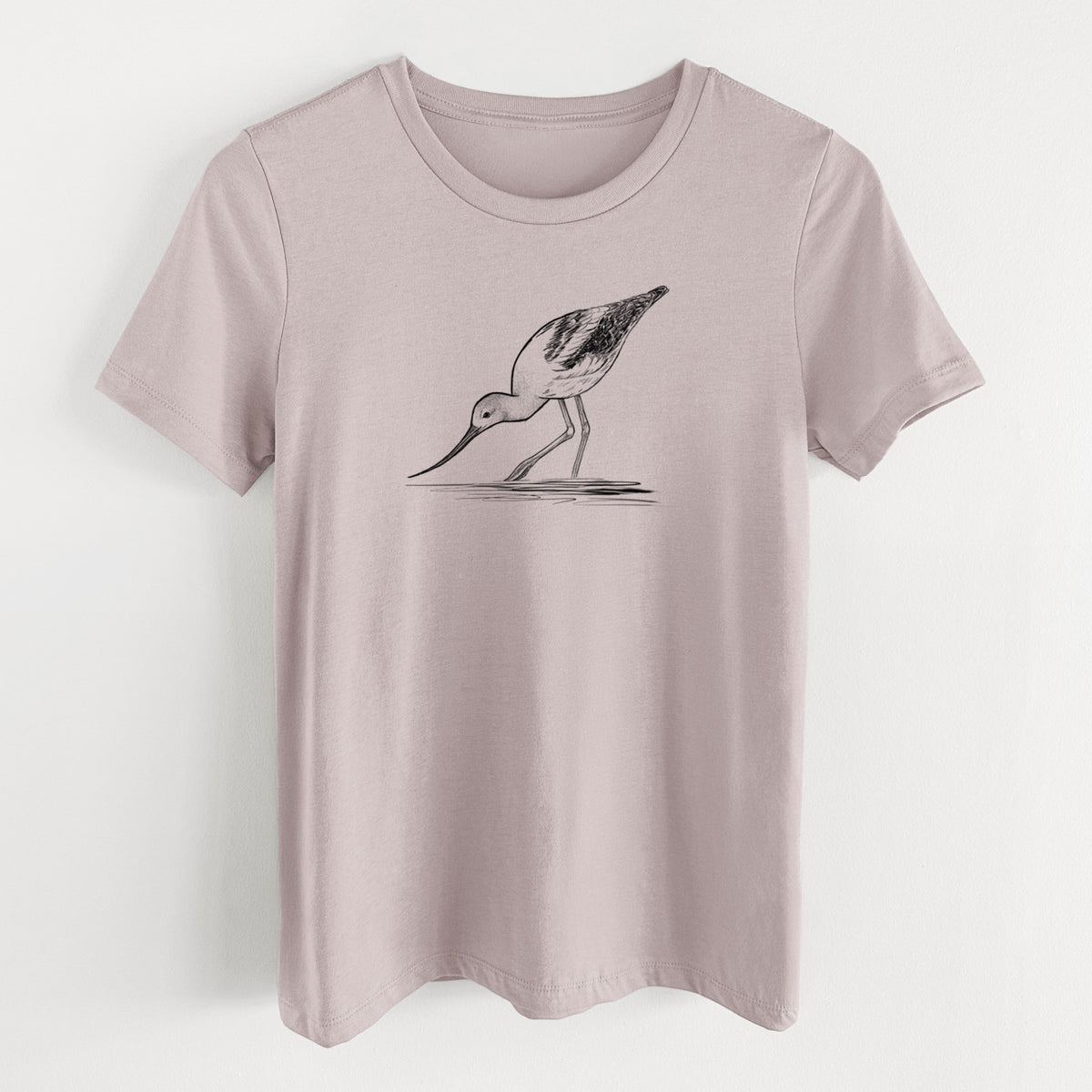 Pink gravel women's relaxed fit cotton t-shirt laid flat, printed with a detailed black ink sketch of an American avocet wading in shallow water.