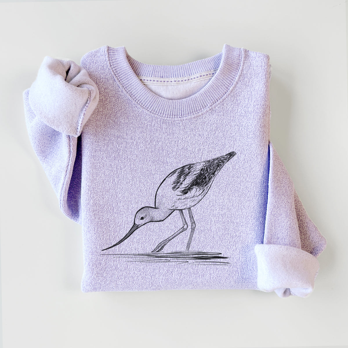 Ice purple knit sweatshirt printed with a detailed black ink sketch of an American avocet wading in shallow water, styled flat.