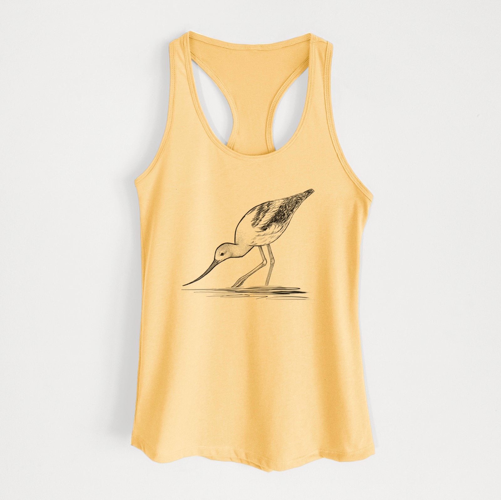 Banana cream women's racerback tank top laid flat, printed with a detailed black ink sketch of an American avocet wading in shallow water.