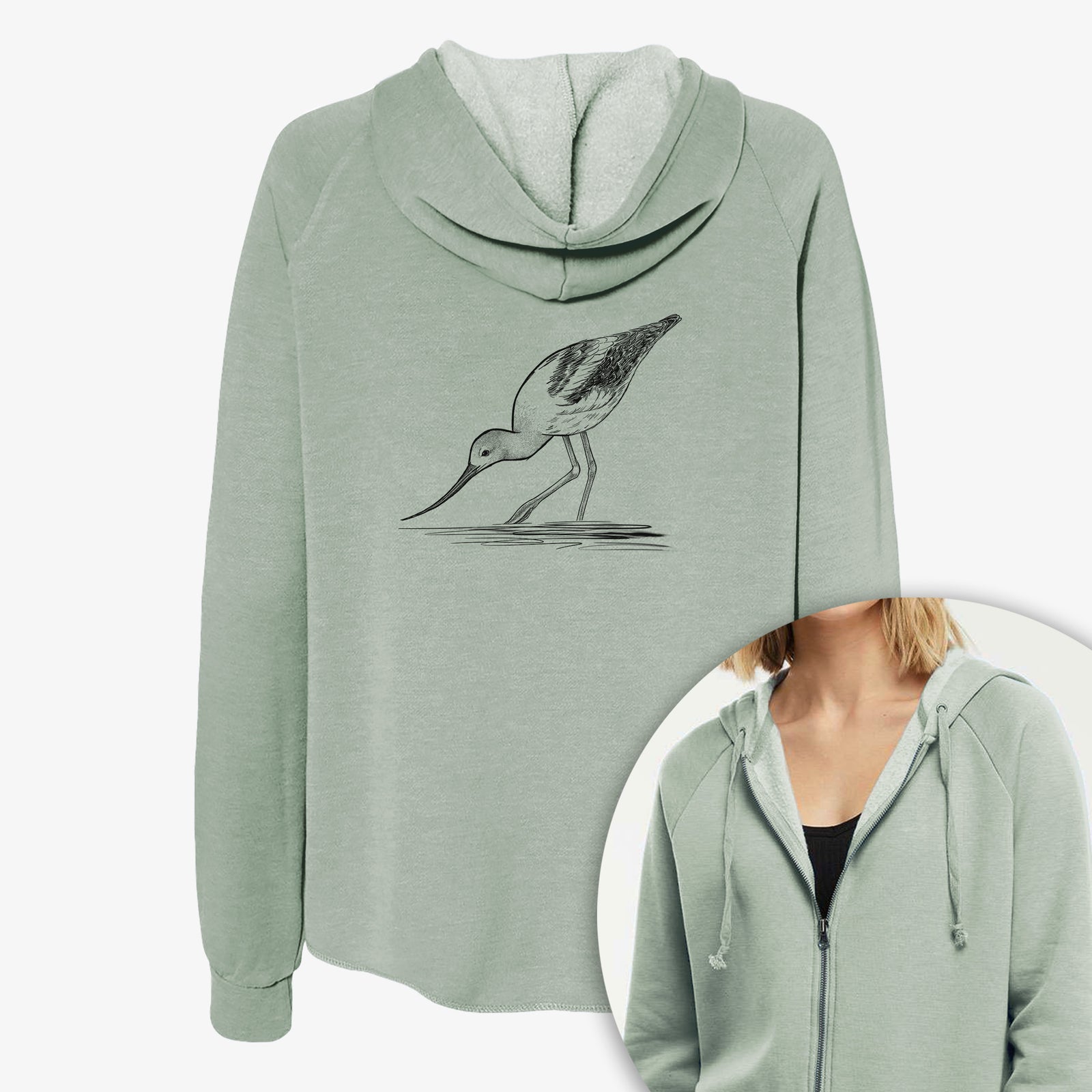 Women's Cali Wave zip-up sweatshirt printed with a detailed black ink sketch of an American avocet wading in shallow water, with a close-up of the zipper.