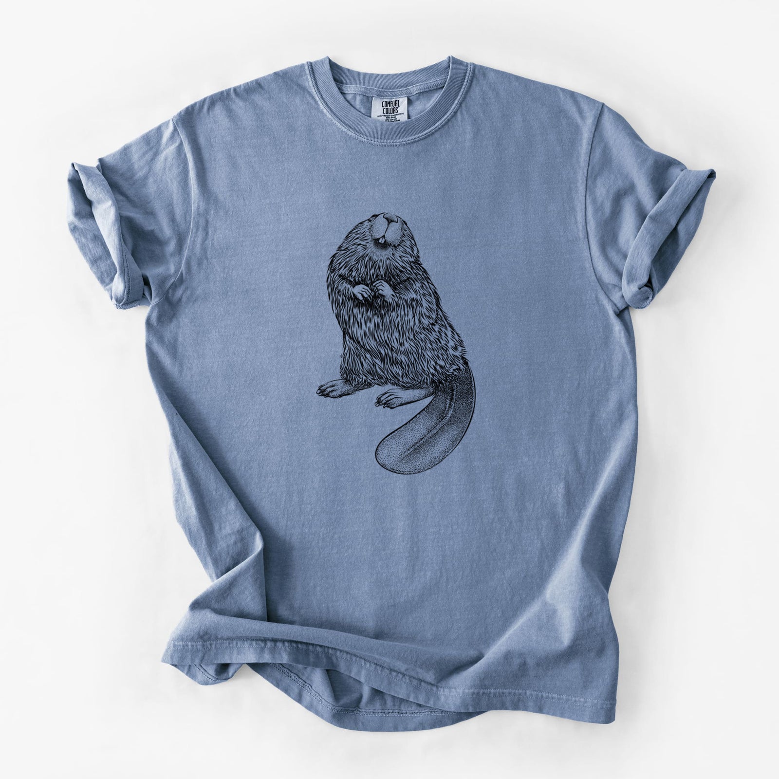 Blue jean Comfort Colors t-shirt laid flat, printed with a detailed black ink illustration of an American beaver sitting upright with its flat tail.