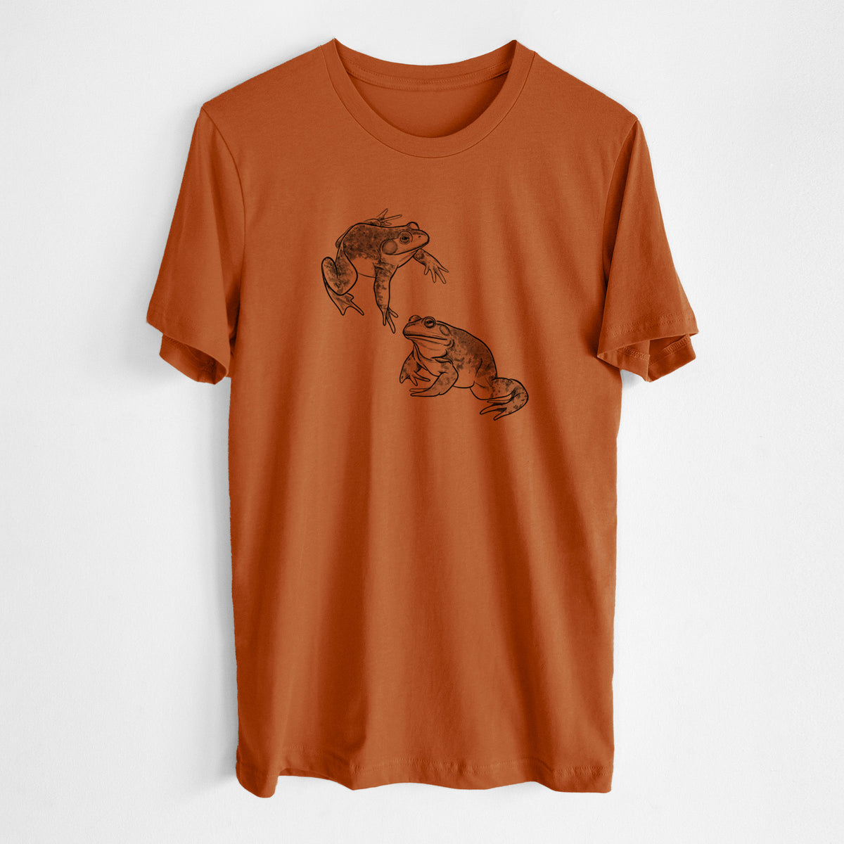 Autumn lightweight cotton t-shirt laid flat, printed with a detailed black ink illustration of two American bullfrogs.