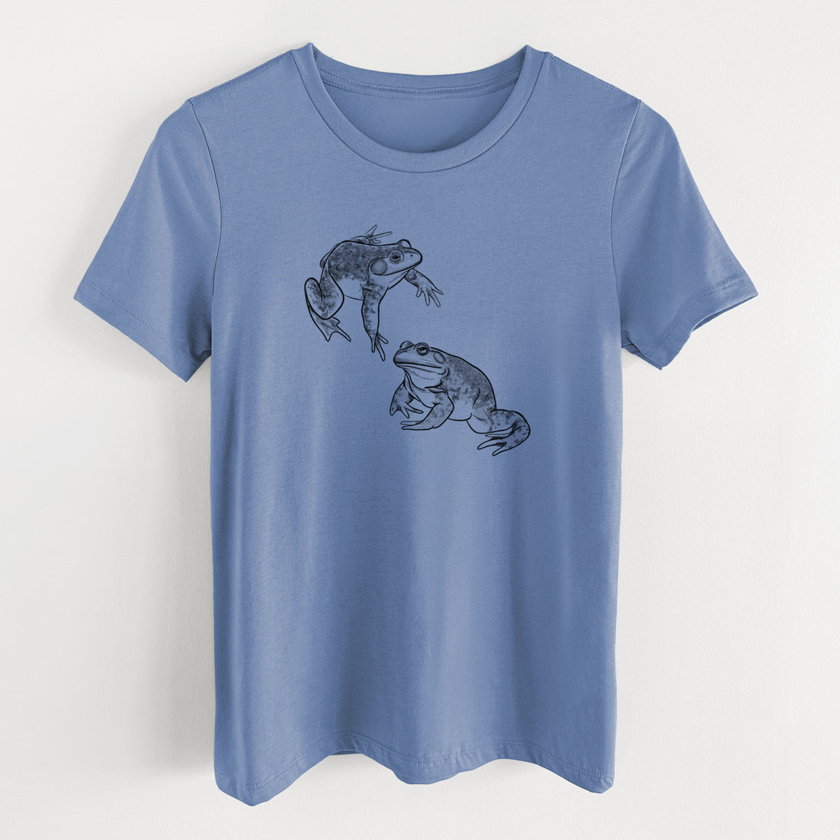Blue bell women's relaxed fit cotton t-shirt laid flat, printed with a detailed black ink illustration of two American bullfrogs.
