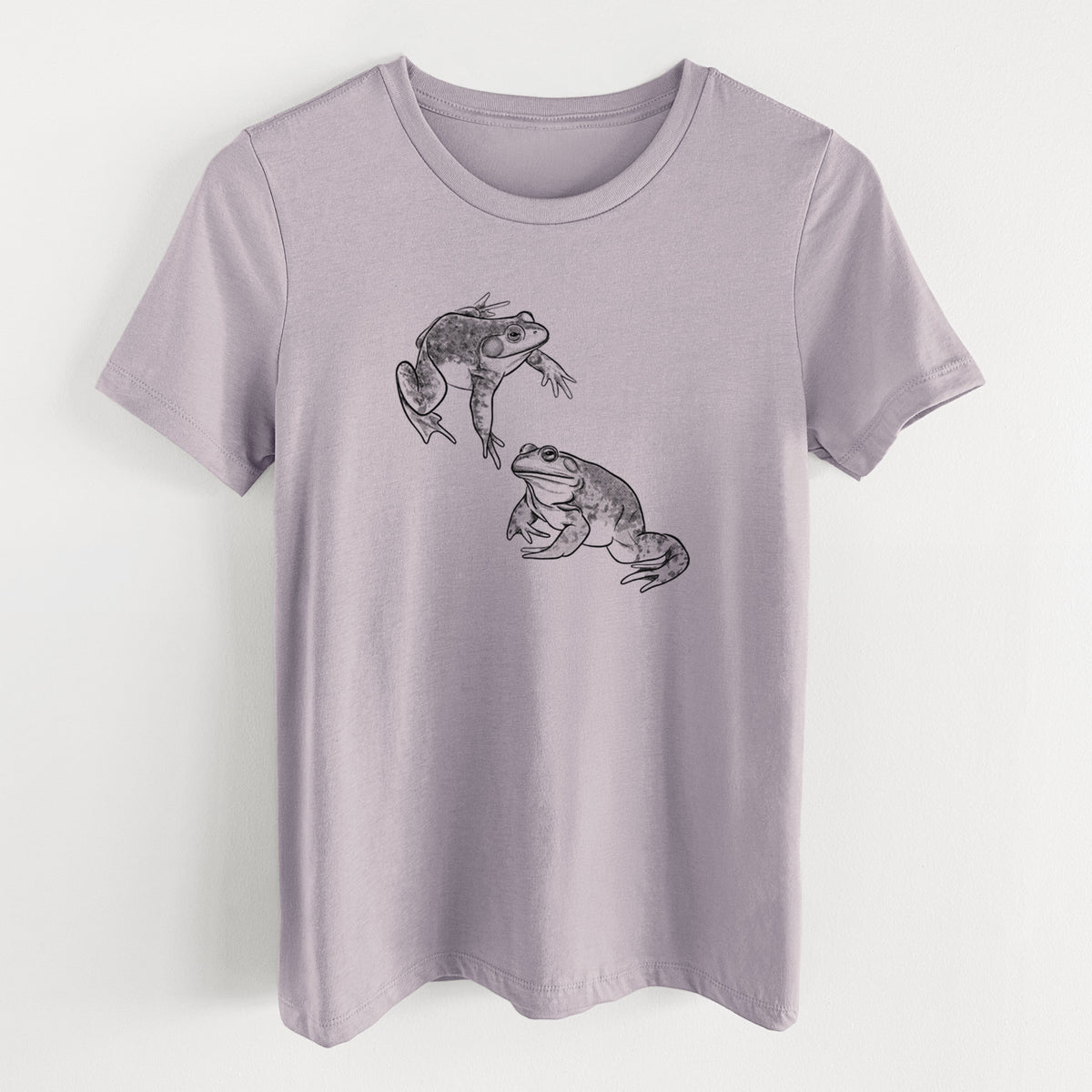 Light violet women's relaxed fit cotton t-shirt laid flat, printed with a detailed black ink illustration of two American bullfrogs.