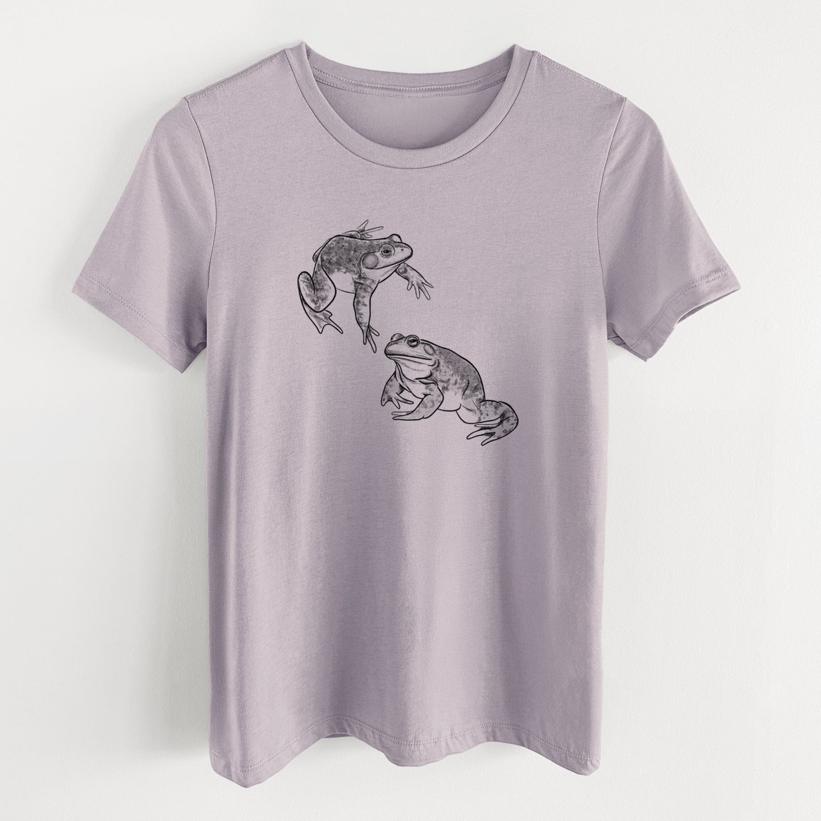 Light violet women's relaxed fit cotton t-shirt laid flat, printed with a detailed black ink illustration of two American bullfrogs.