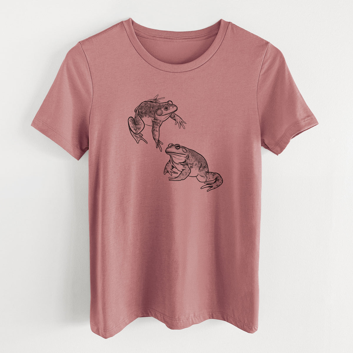 Mauve pink women's relaxed fit cotton t-shirt laid flat, printed with a detailed black ink illustration of two American bullfrogs.