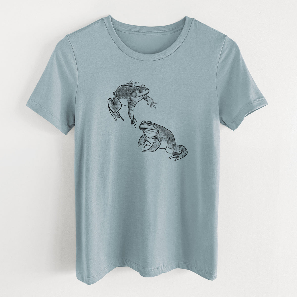 Vintage denim women's relaxed fit cotton t-shirt laid flat, printed with a detailed black ink illustration of two American bullfrogs.