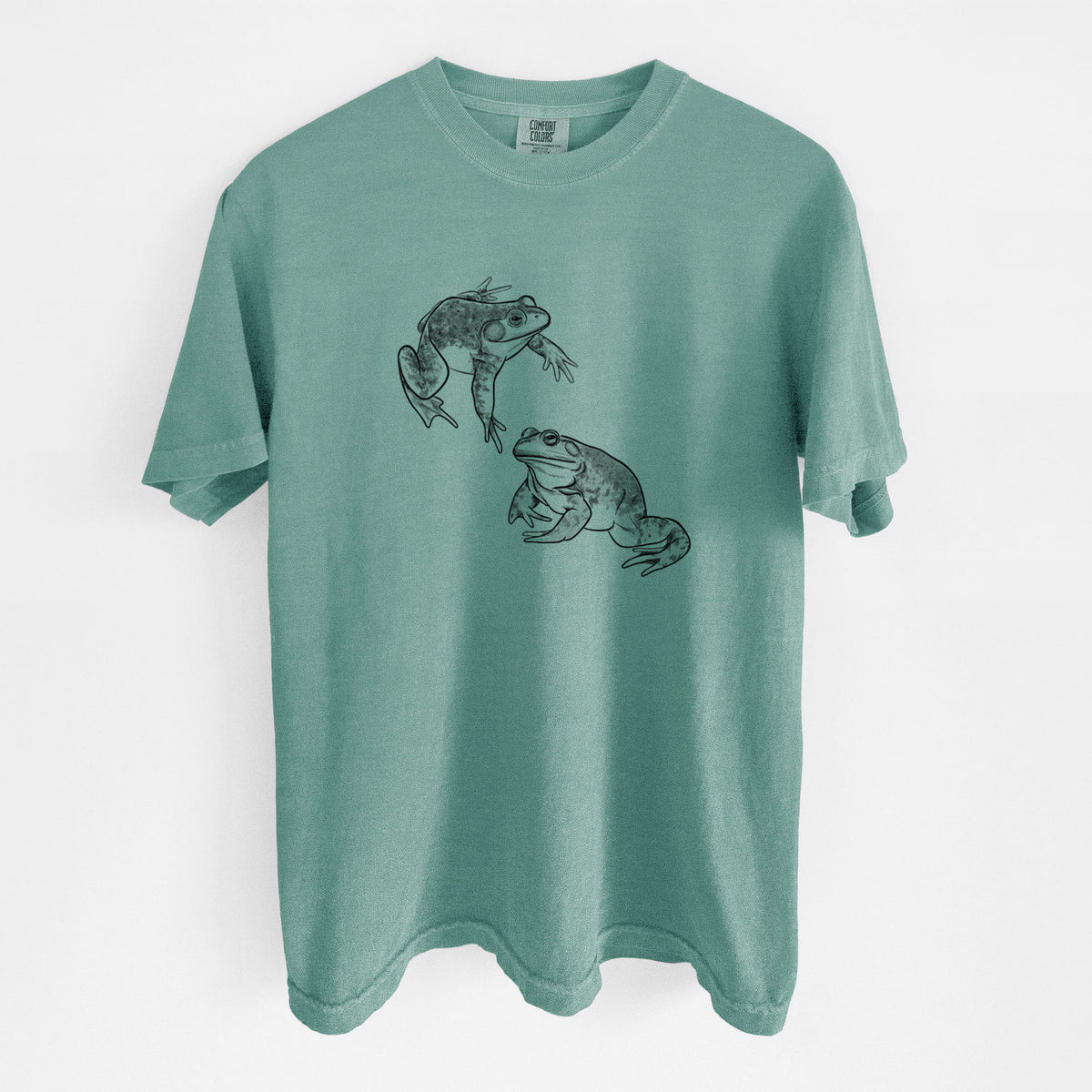 Reef green Comfort Colors t-shirt laid flat, printed with a detailed black ink illustration of two American bullfrogs.