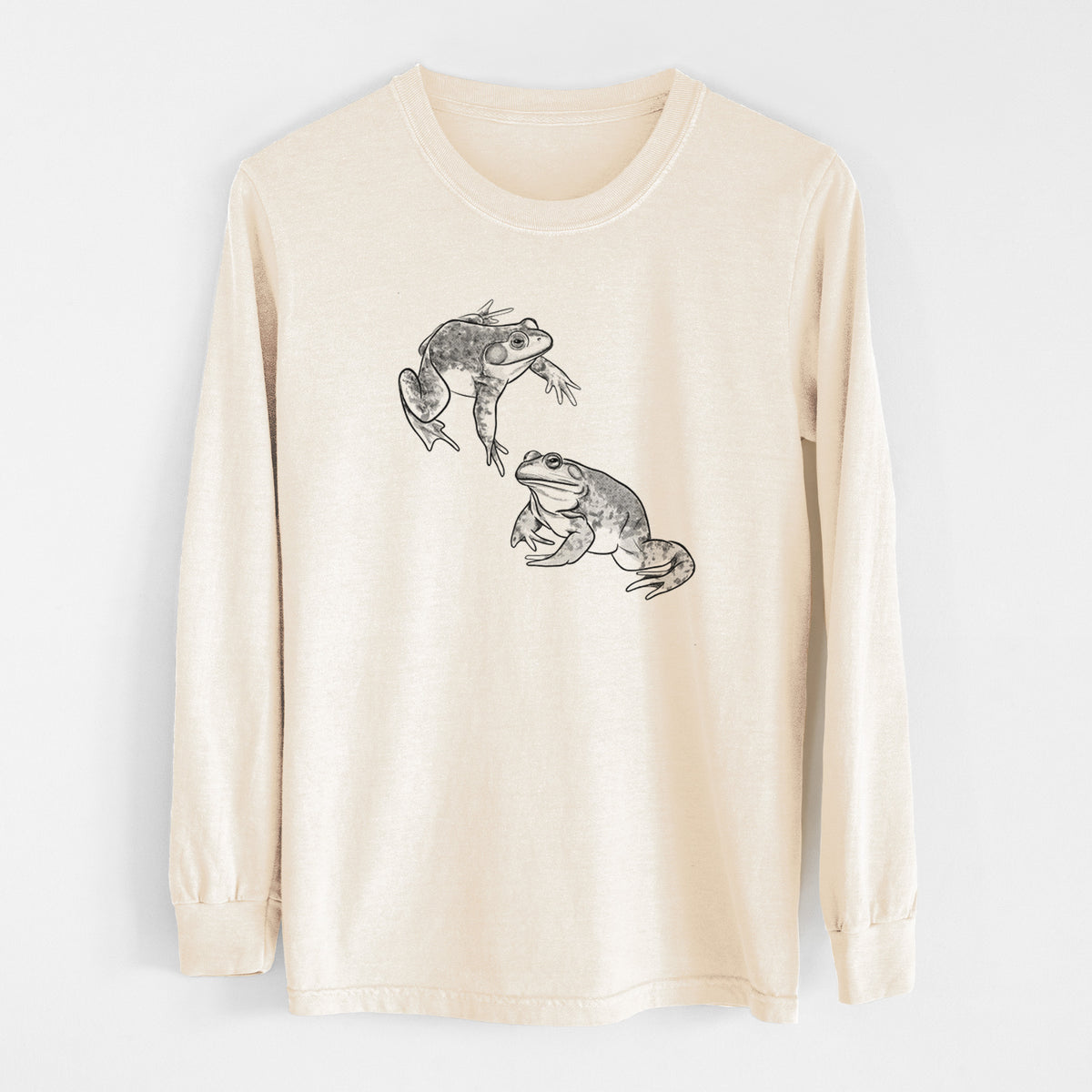 Ivory Comfort Colors long sleeve shirt laid flat, printed with a detailed black ink illustration of two American bullfrogs.