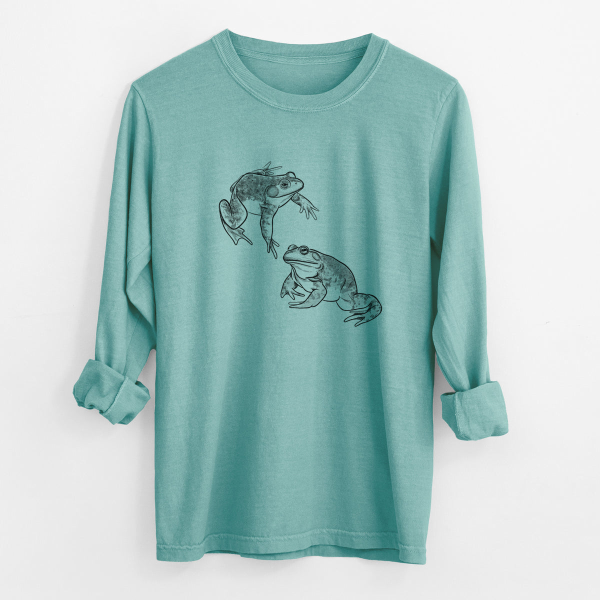 Reef green Comfort Colors long sleeve shirt laid flat with the cuffs rolled, printed with a detailed black ink illustration of two American bullfrogs.