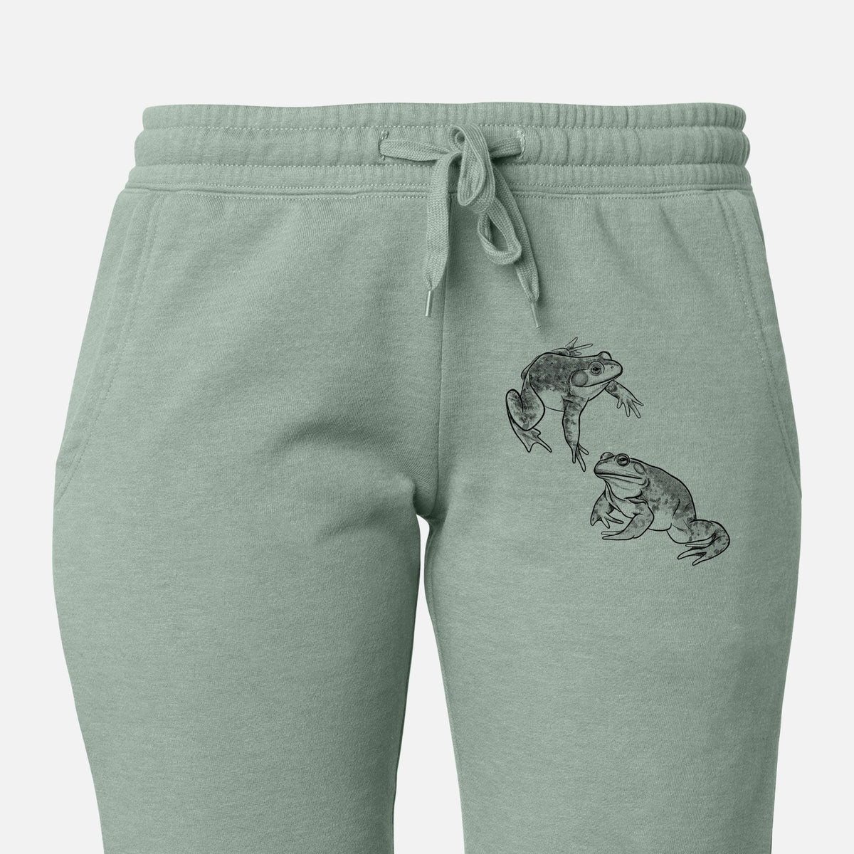 Front of sage green Cali Wave sweatpants, printed with a detailed black ink illustration of two American bullfrogs on the leg.