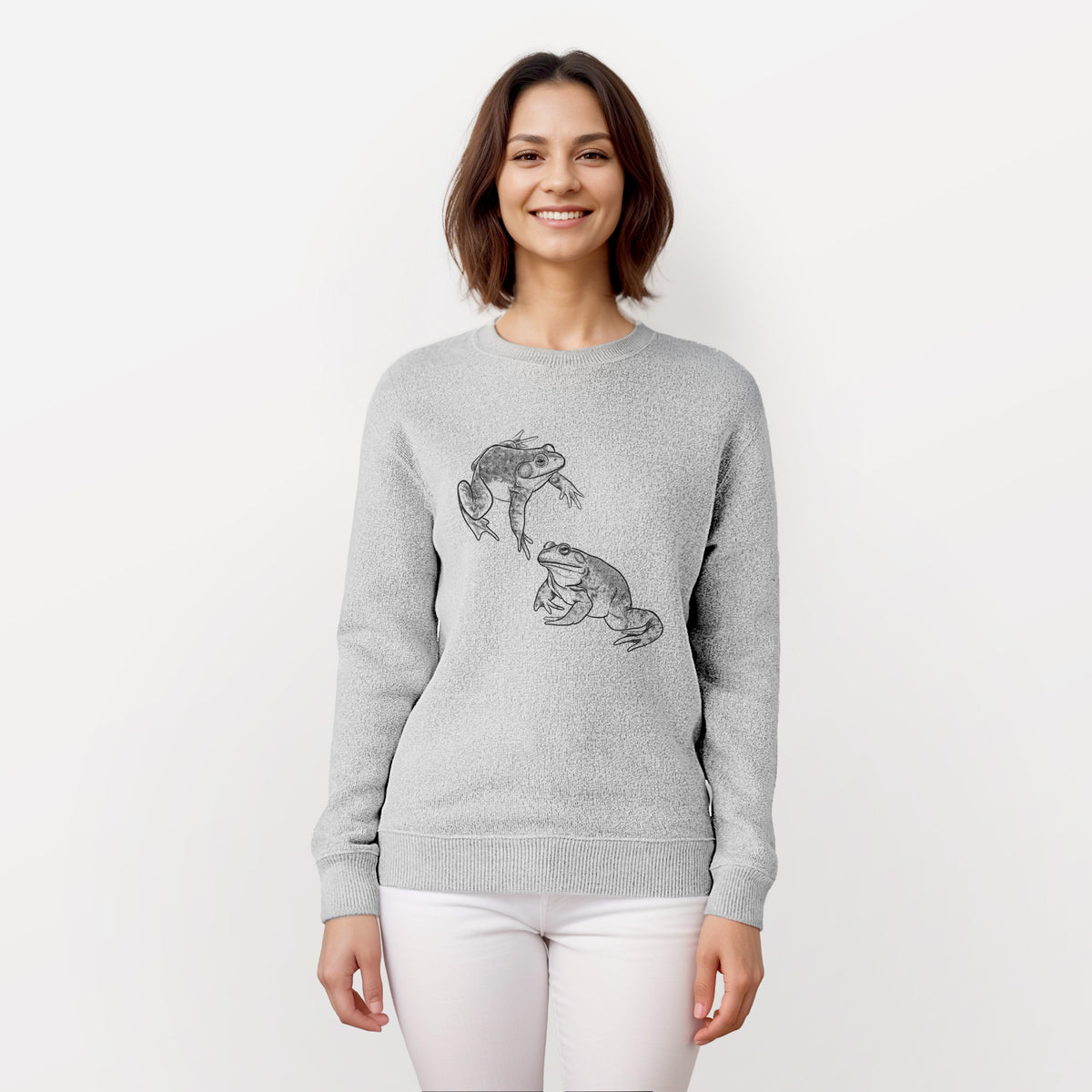 Woman wearing a knit sweatshirt printed with a detailed black ink illustration of two American bullfrogs.