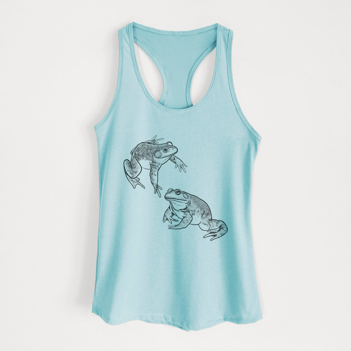 Cancun blue women's racerback tank top laid flat, printed with a detailed black ink illustration of two American bullfrogs.