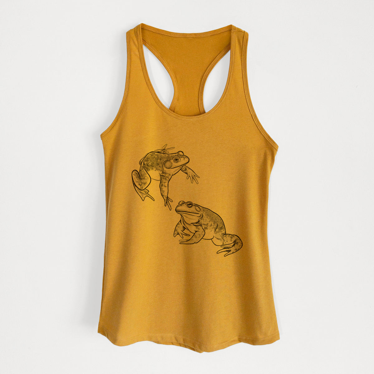 Gold women's racerback tank top laid flat, printed with a detailed black ink illustration of two American bullfrogs.