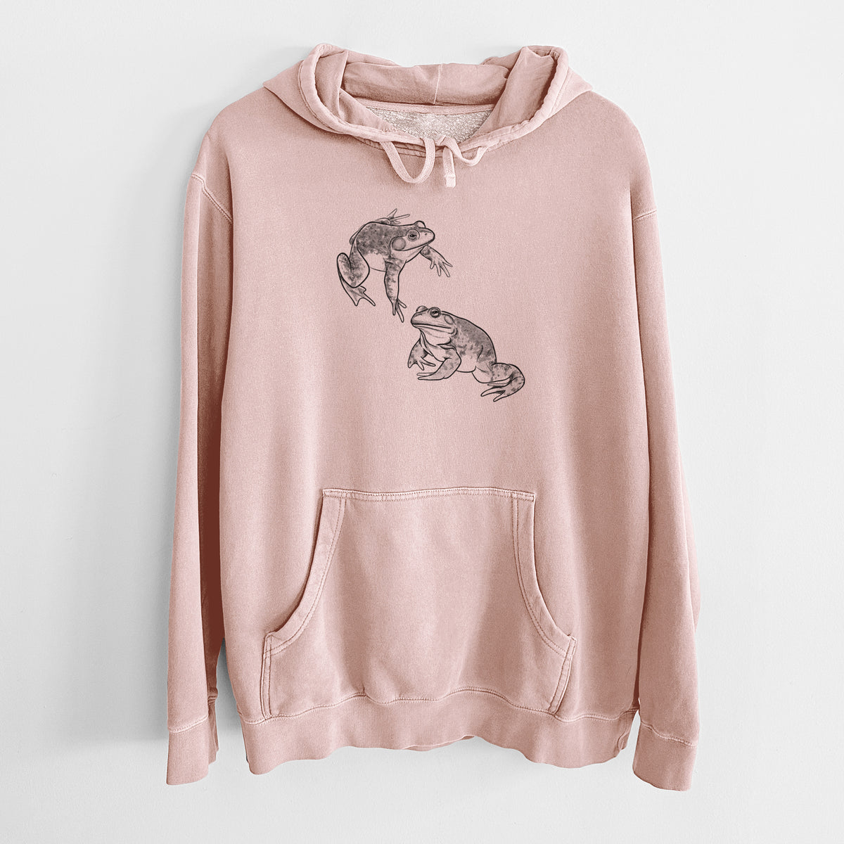 Dusty pink pigment dyed hoodie laid flat, printed with a detailed black ink illustration of two American bullfrogs.