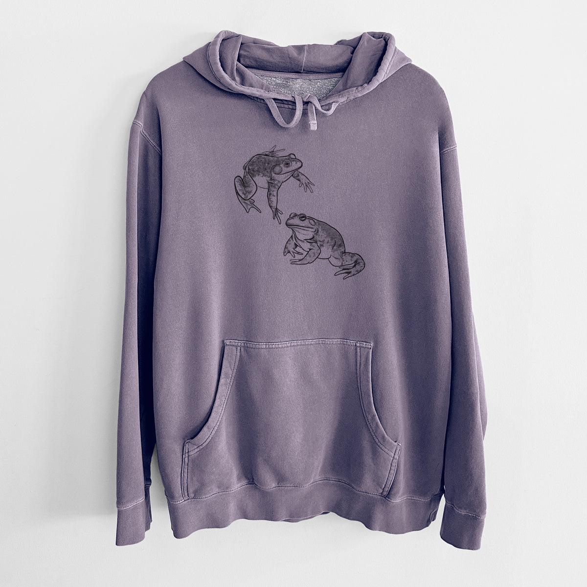 Plum purple pigment dyed hoodie laid flat, printed with a detailed black ink illustration of two American bullfrogs.