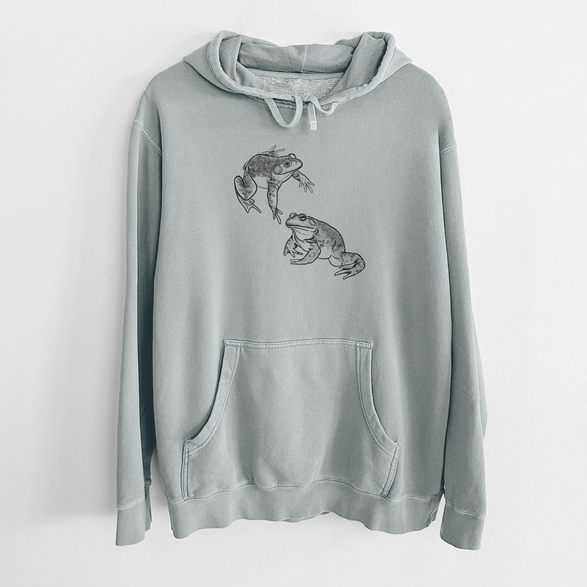 Sage green pigment dyed hoodie laid flat, printed with a detailed black ink illustration of two American bullfrogs.