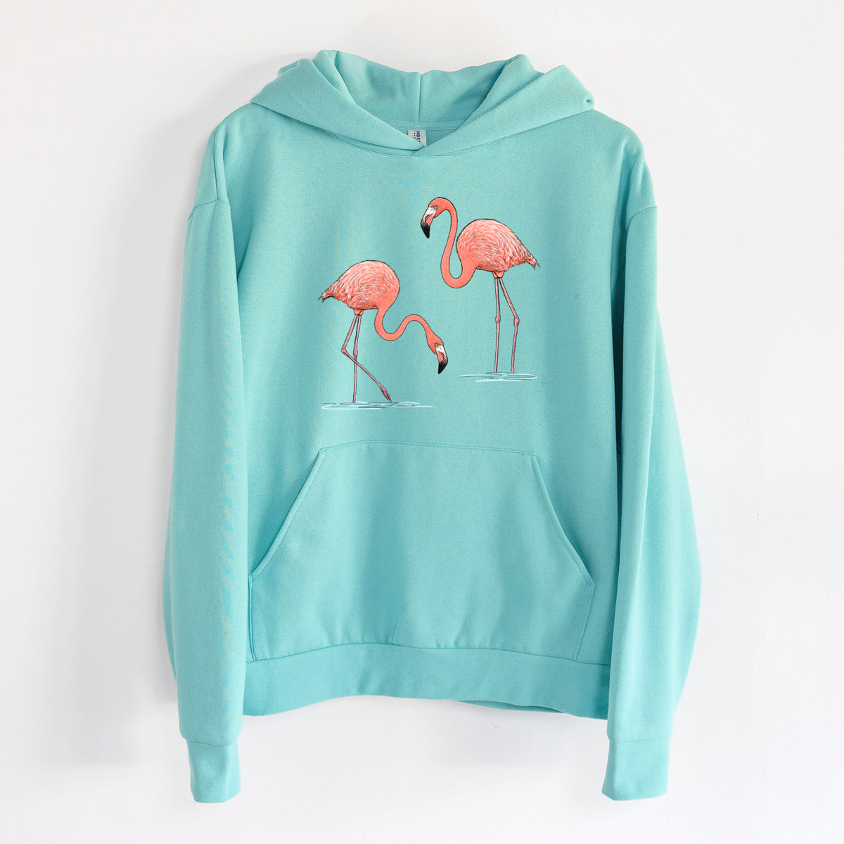 American Flamingos - Phoenicopterus ruber - Statement Midweight Hoodie in Seafoam, hanging on a white wall, with a front kangaroo pocket and no drawcords.