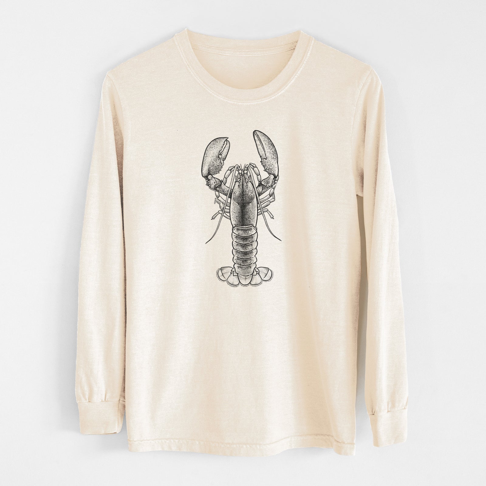 Ivory Comfort Colors long sleeve shirt laid flat, printed with a detailed black ink illustration of an American lobster with its claws raised, seen from above.