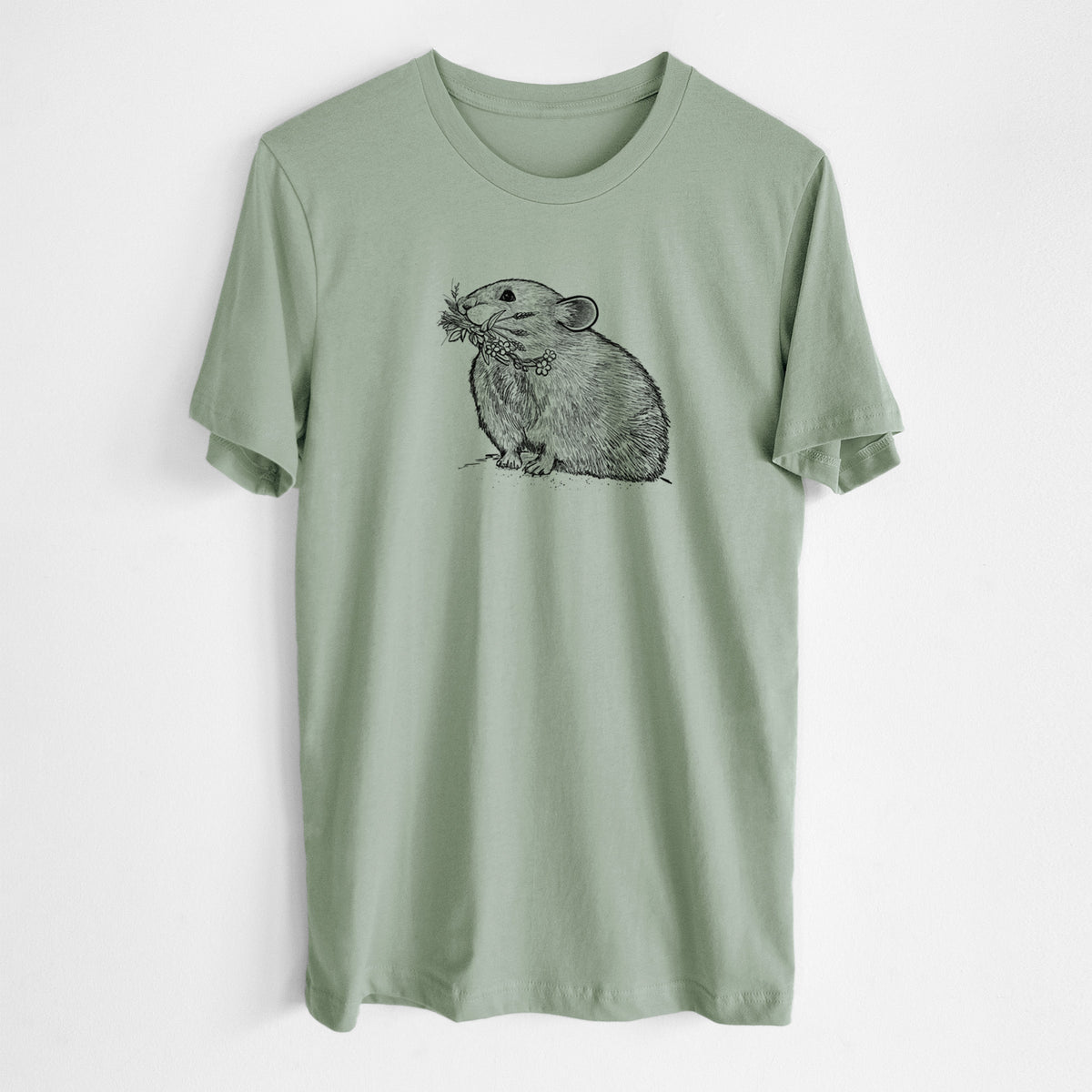 Sage green lightweight cotton t-shirt laid flat, printed with a detailed black ink illustration of an American pika holding flowers and grass in its mouth.