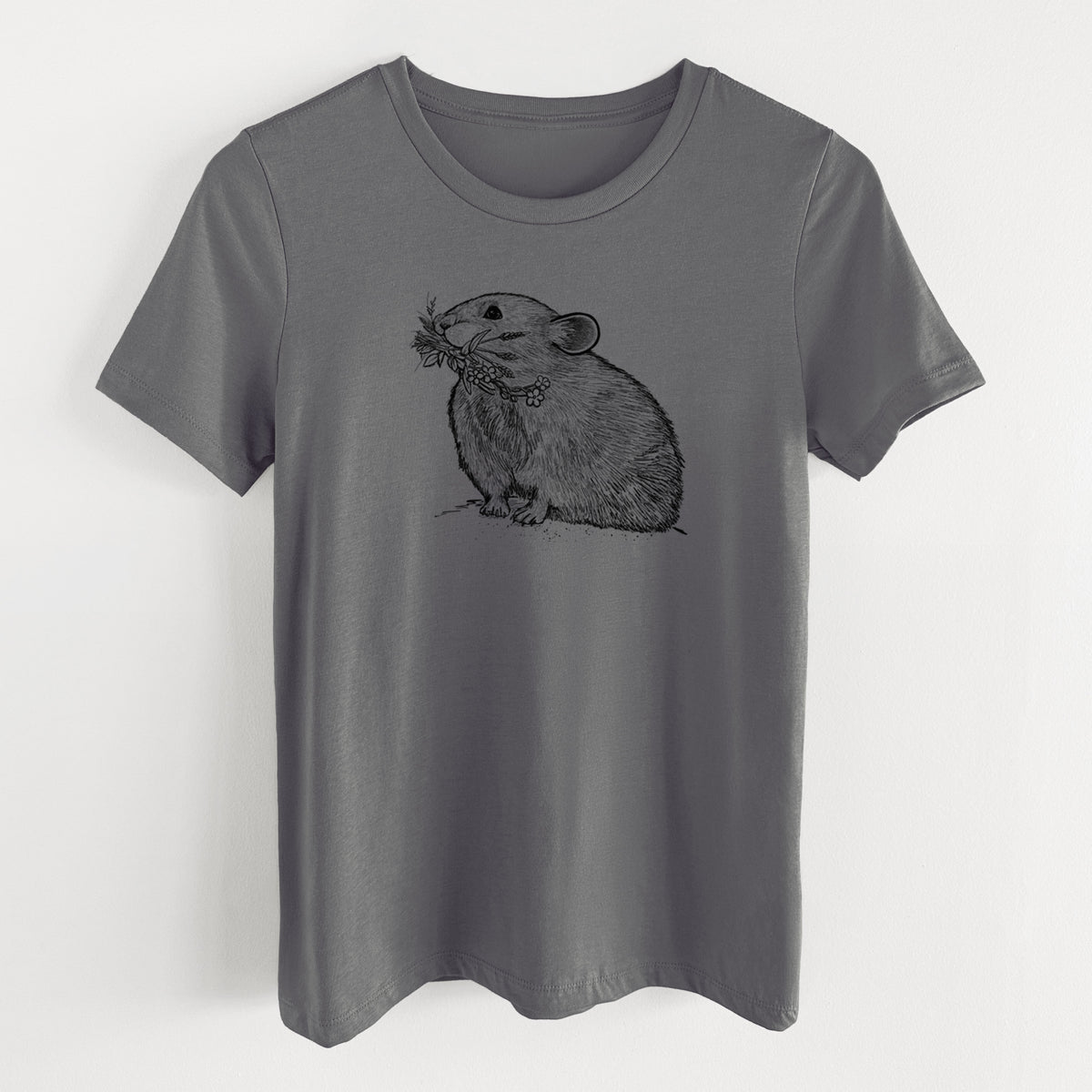Asphalt women's relaxed fit cotton t-shirt laid flat, printed with a detailed black ink illustration of an American pika holding flowers and grass in its mouth.