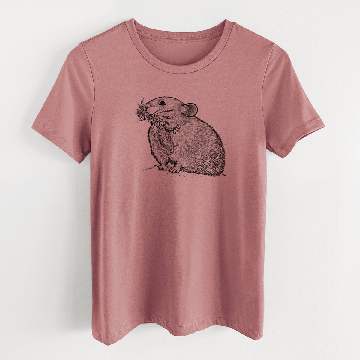 Mauve pink women's relaxed fit cotton t-shirt laid flat, printed with a detailed black ink illustration of an American pika holding flowers and grass in its mouth.