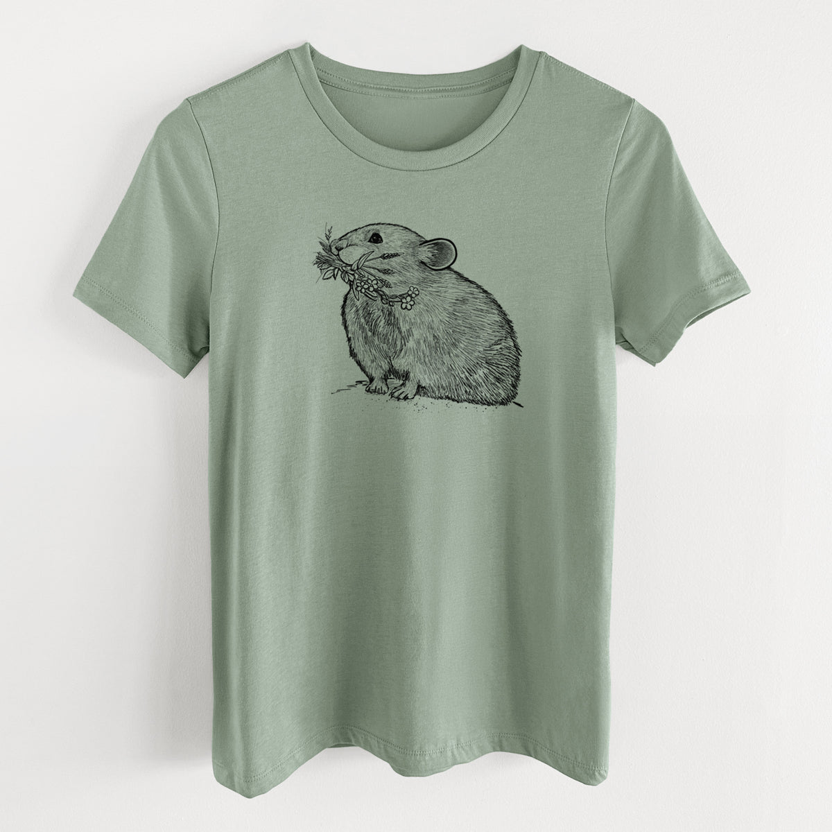 Sage green women's relaxed fit cotton t-shirt laid flat, printed with a detailed black ink illustration of an American pika holding flowers and grass in its mouth.