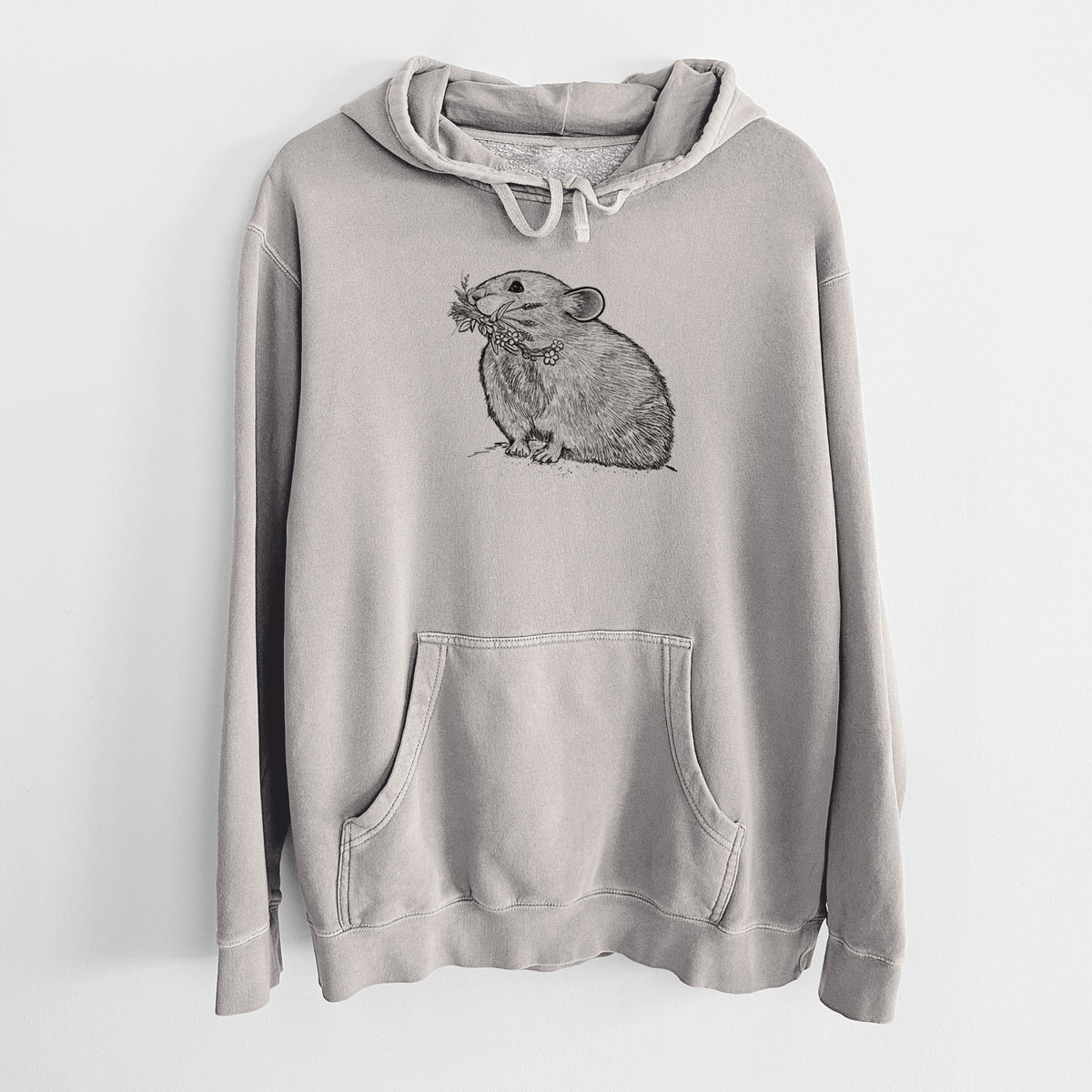 Cement grey pigment dyed hoodie laid flat, printed with a detailed black ink illustration of an American pika holding flowers and grass in its mouth.