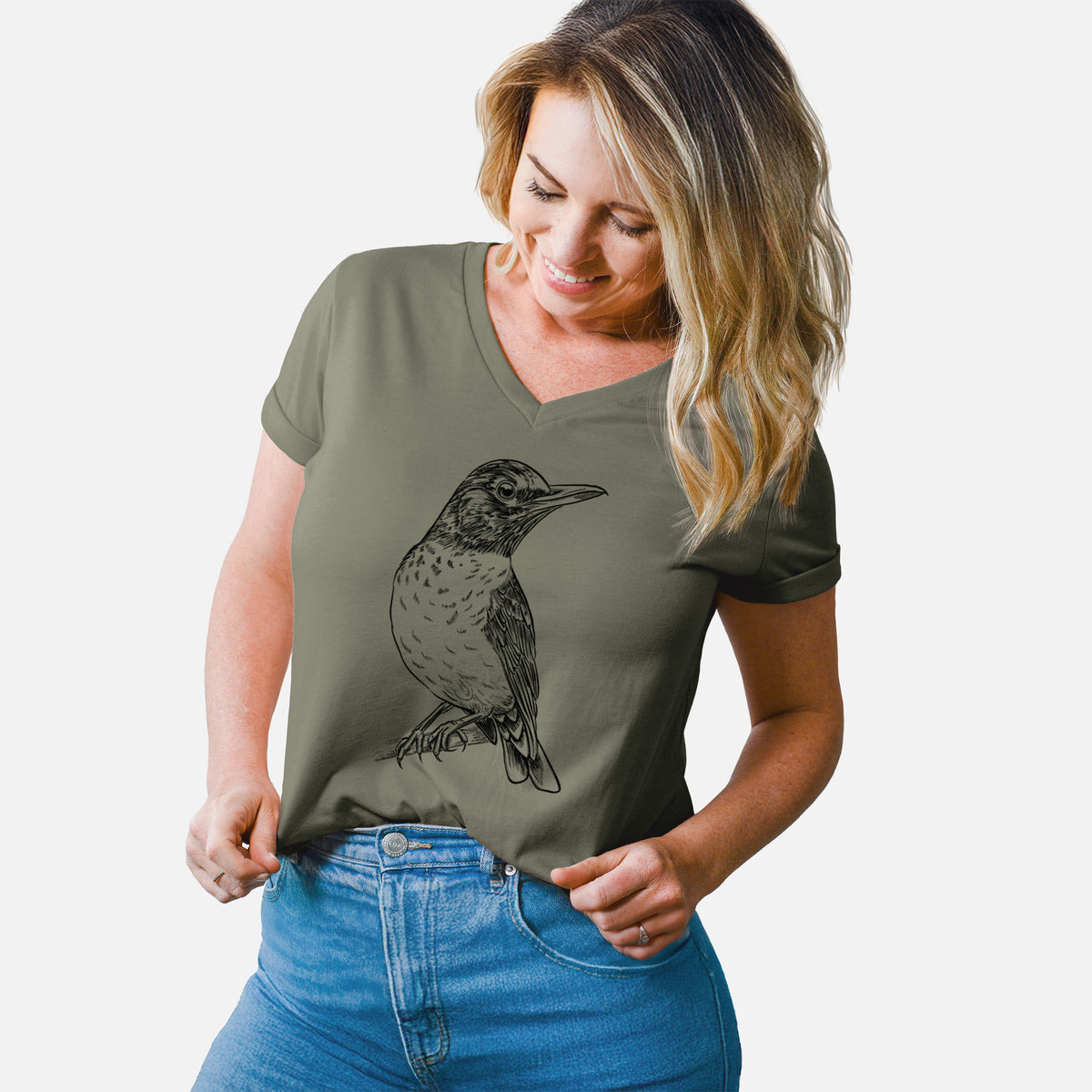 Woman wearing a military green women's relaxed fit cotton V-neck t-shirt printed with a detailed black ink sketch of an American robin perched on a branch.