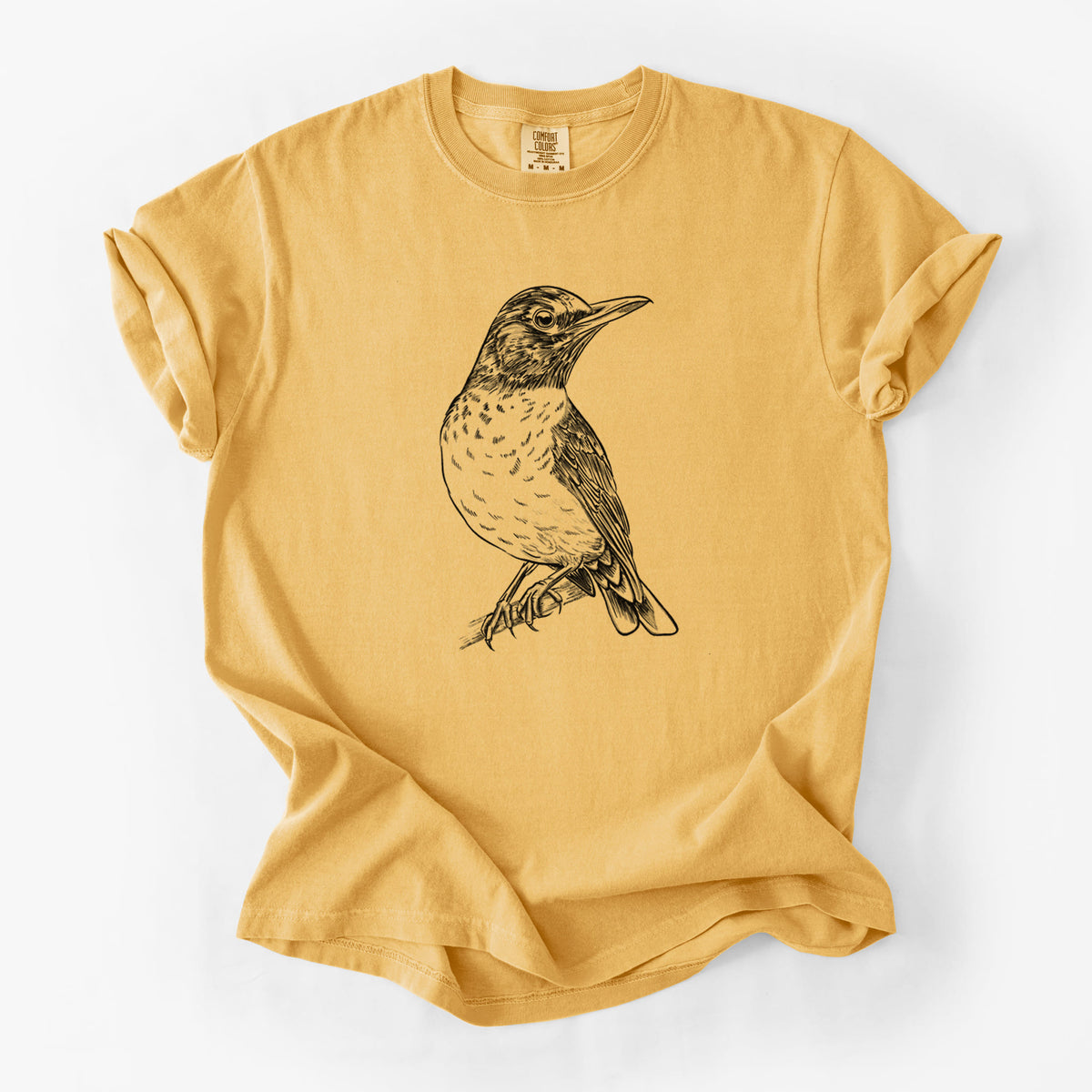 Golden wheat yellow Comfort Colors t-shirt laid flat, printed with a detailed black ink sketch of an American robin perched on a branch.