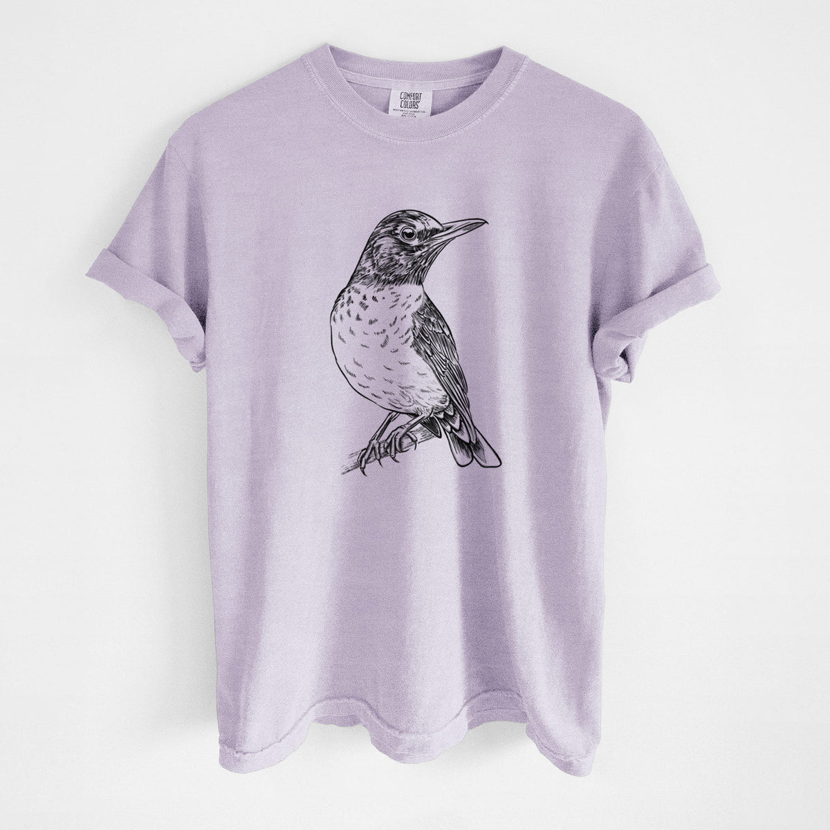 Orchid purple Comfort Colors t-shirt laid flat, printed with a detailed black ink sketch of an American robin perched on a branch.