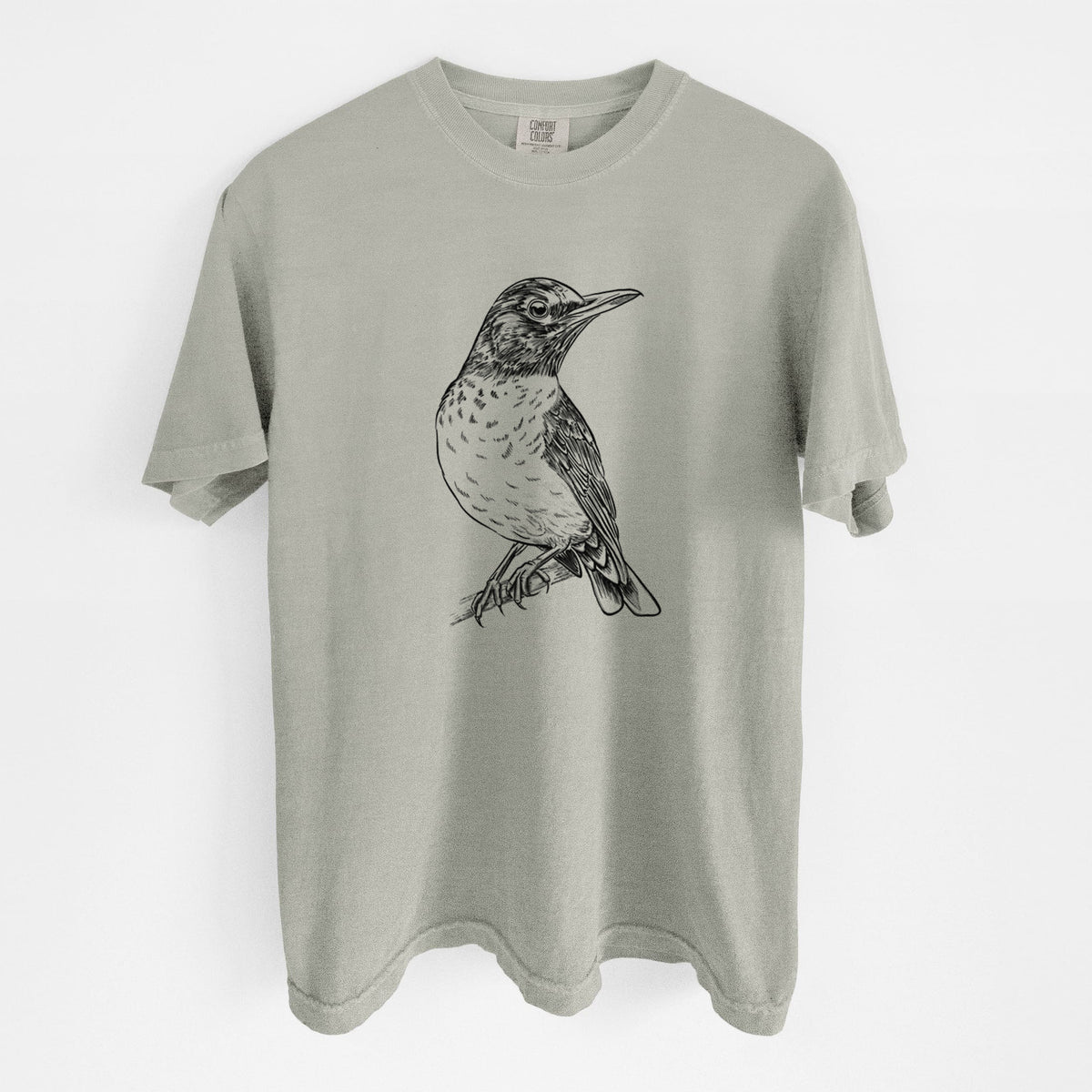 Sandstone beige Comfort Colors t-shirt laid flat, printed with a detailed black ink sketch of an American robin perched on a branch.