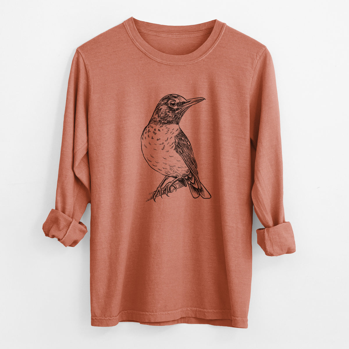 Yam burnt orange Comfort Colors long sleeve shirt laid flat with the cuffs rolled, printed with a detailed black ink sketch of an American robin perched on a branch.