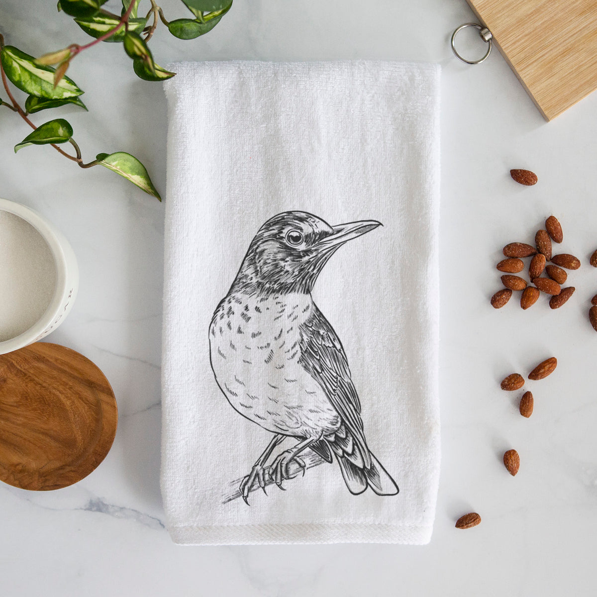 White hand towel printed with a detailed black ink sketch of an American robin perched on a branch.
